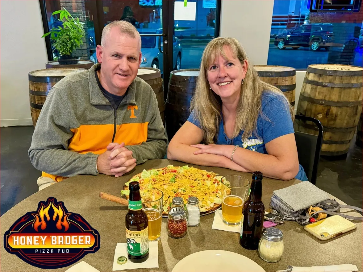 Two guests sharing nachos by the barrels